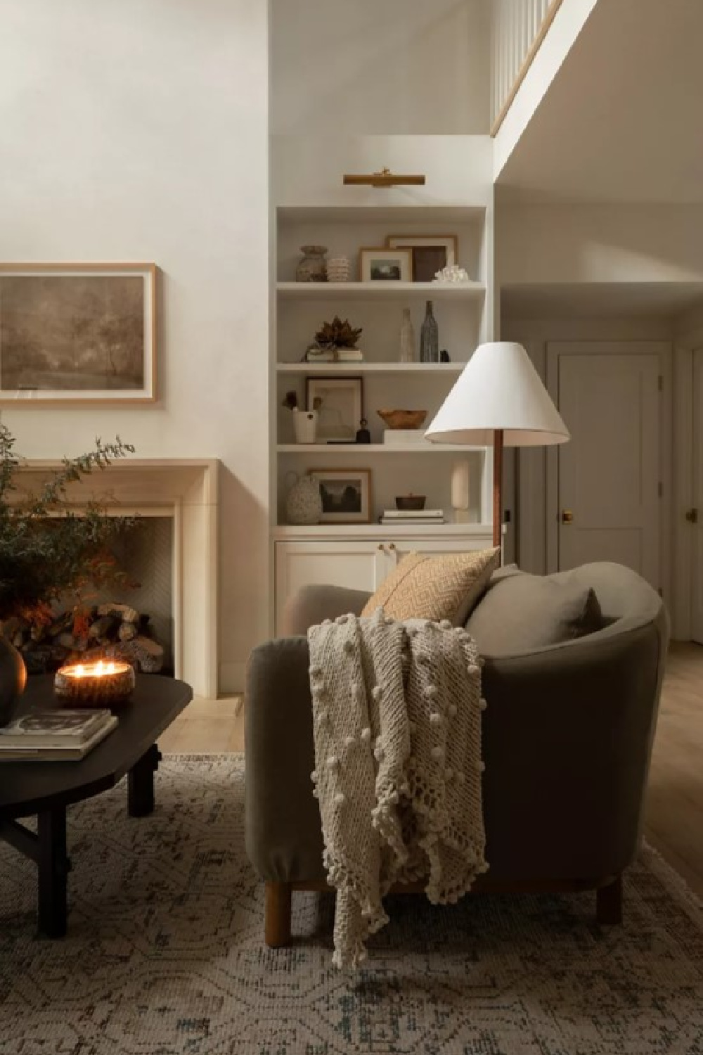 Cozy California cool living room with stone fireplace, builtins, and sofa with knit throw - Amber Lewis. #modernrustic #livingrooms