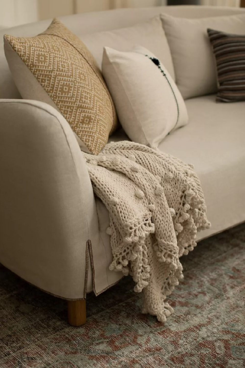 Knit throw by Amber Lewis on a beautiful modern rustic sofa. #knitthrow #modernrustic #amberlewis