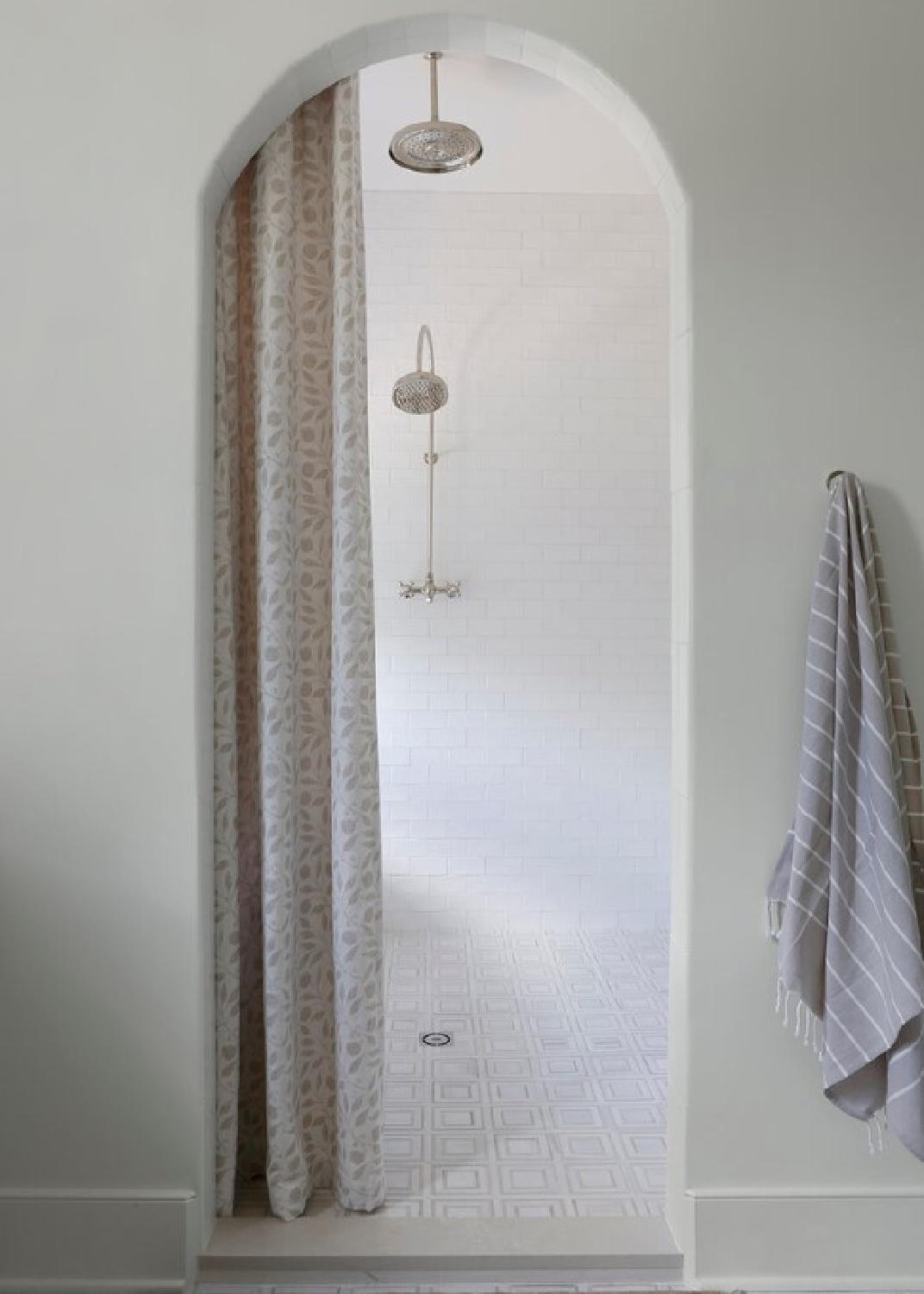 Beautiful arched opening to shower with subway tile - design by April Tomlin. #customshower #custombathroomdesign