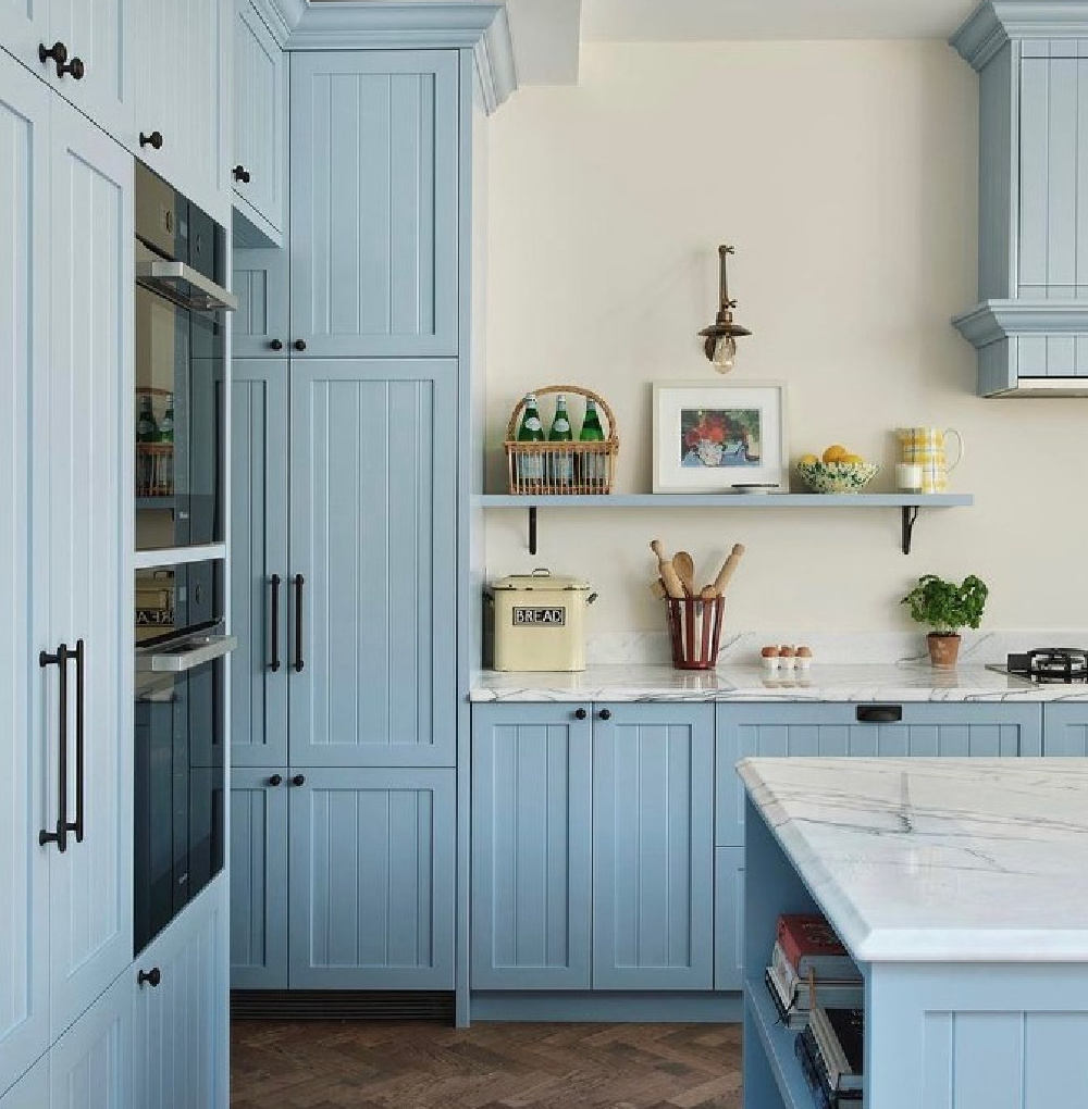 Sky blue kitchen cabinets and herringbone wood floors in a charming kitchen by @blockhousebuild. #bluekitchens #skyblue