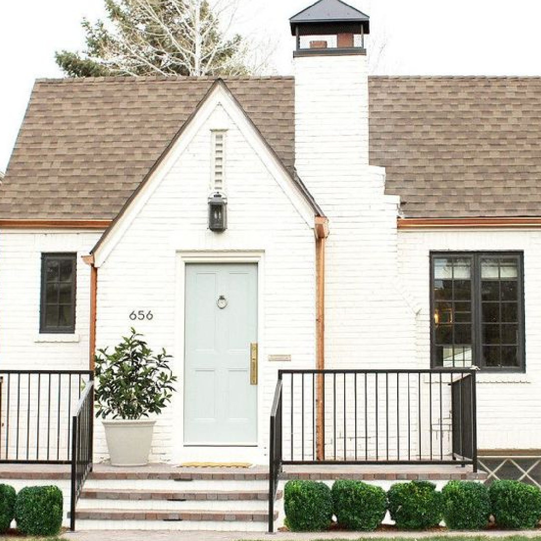 BM China White paint color on Tudor house exterior with black trim and light grey door - Studio McGee #bmchinawhite #whitepaintcolors