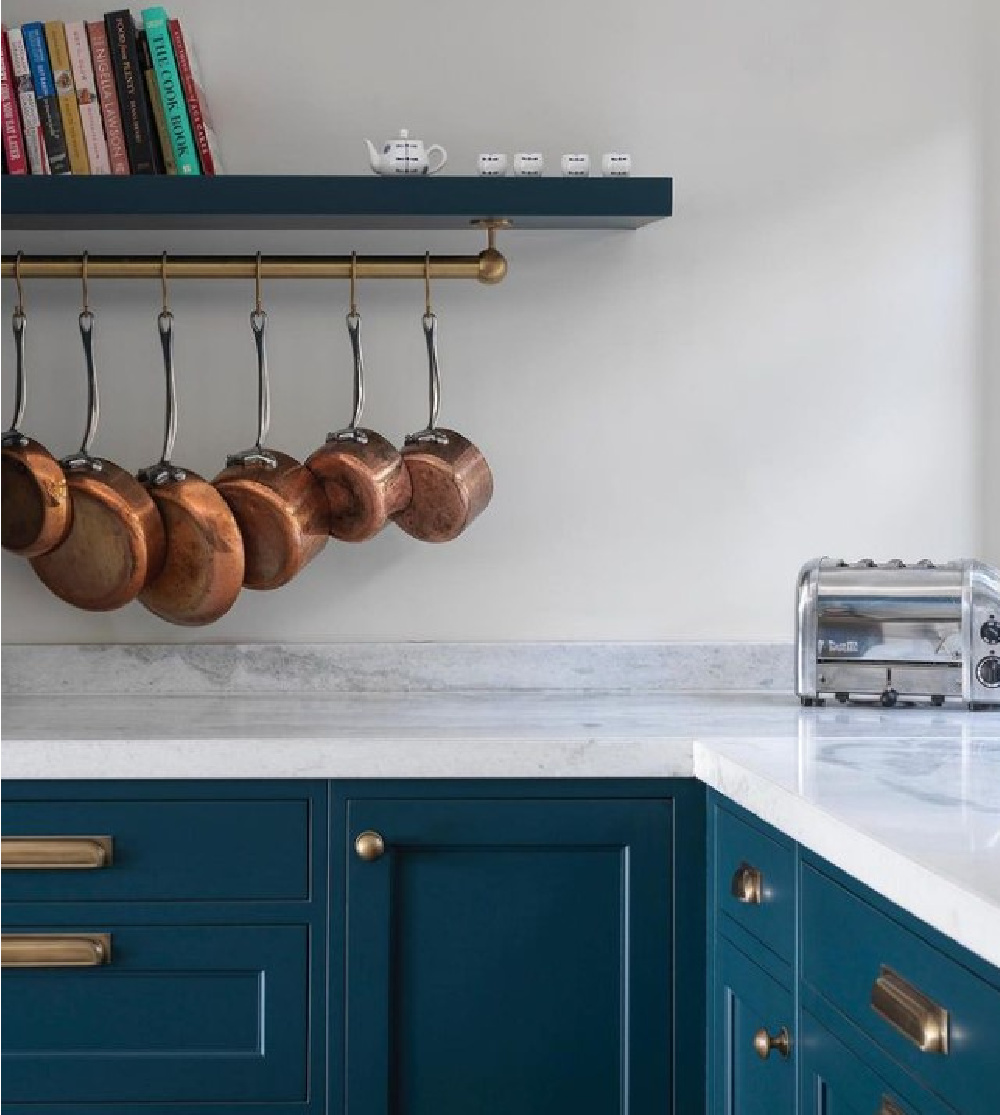Hague Blue (Farrow & Ball) painted cabinets in a beautiful English country style kitchen with copper pans hanging from rack - @brownlowfurniture. #bluekitchens #hagueblue #bespokekitchens