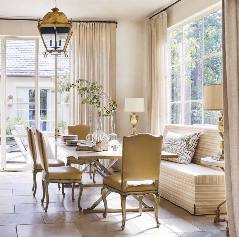 Gorgeous French inspired kitchen with limestone floors, old lantern pendant and banquette in breakfast nook - Carolyn Malone. #frenchcountrykitchen #breakfastnooks