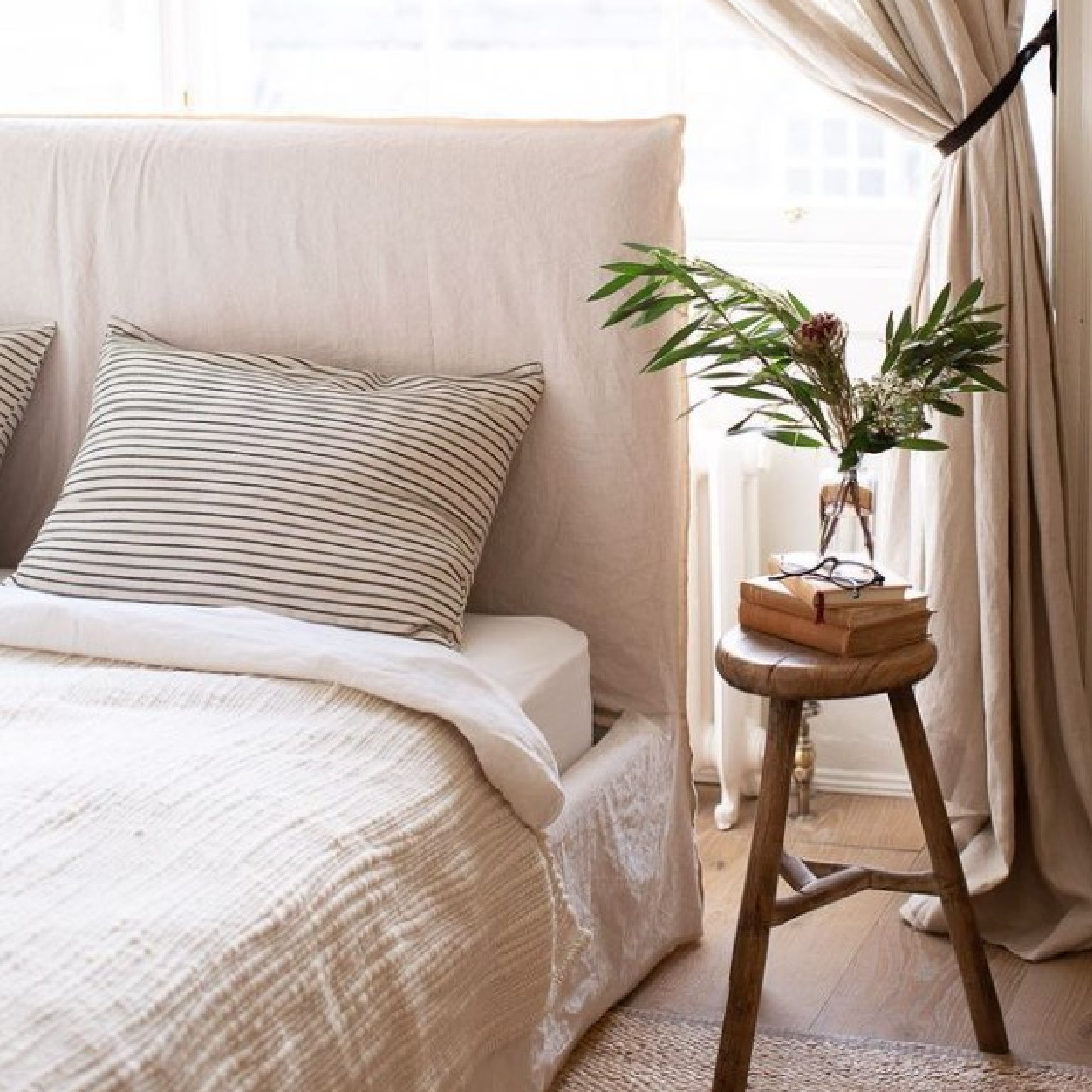 Belgian linen bedding in a lovely minimal luxe bedroom with rustic bedside stool table - @elleihome. #belgianchic #belgianlinen