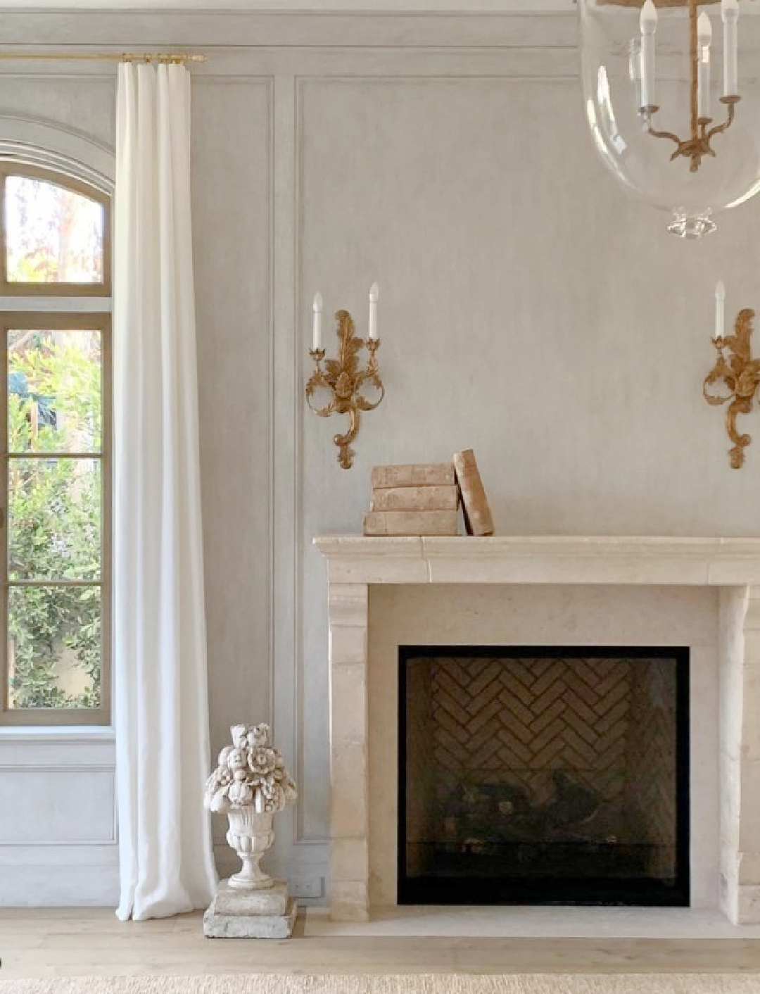 Serene modern French living room with antique limestone fireplace and Old World style - Velvet and Linen. #giannettihome