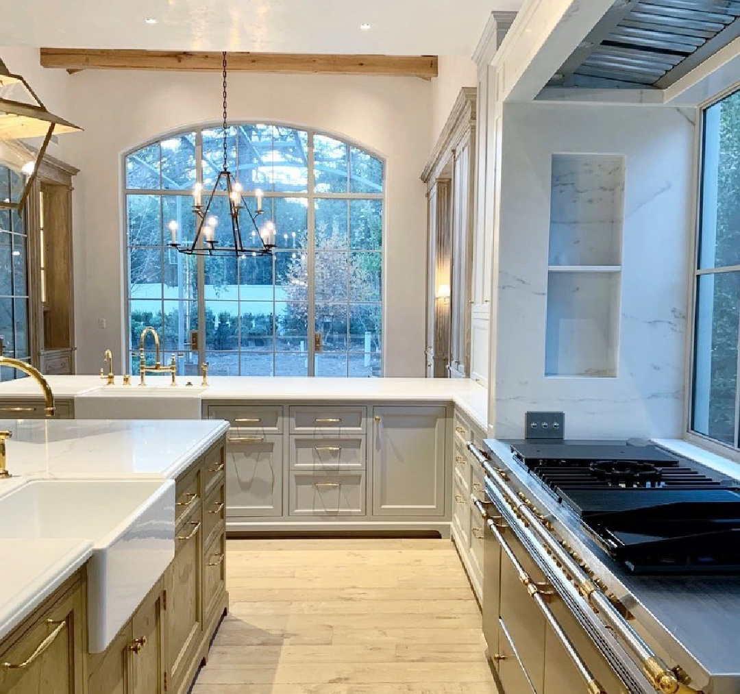 Pavilion Gray (Farrow & Ball) painted kitchen cabinets in a luxurious kitchen by Giannetti Home. #modernfrench #kitchendesign