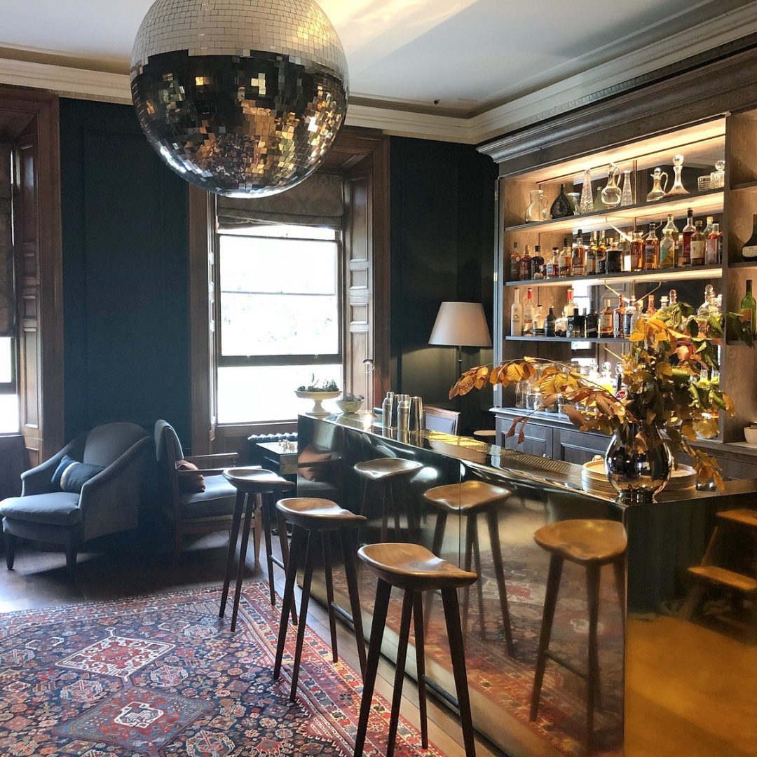 Moon Bar at Heckfield Place is painted in midnight blue and features a disco ball and mirrored bar. #bars #englishcountry