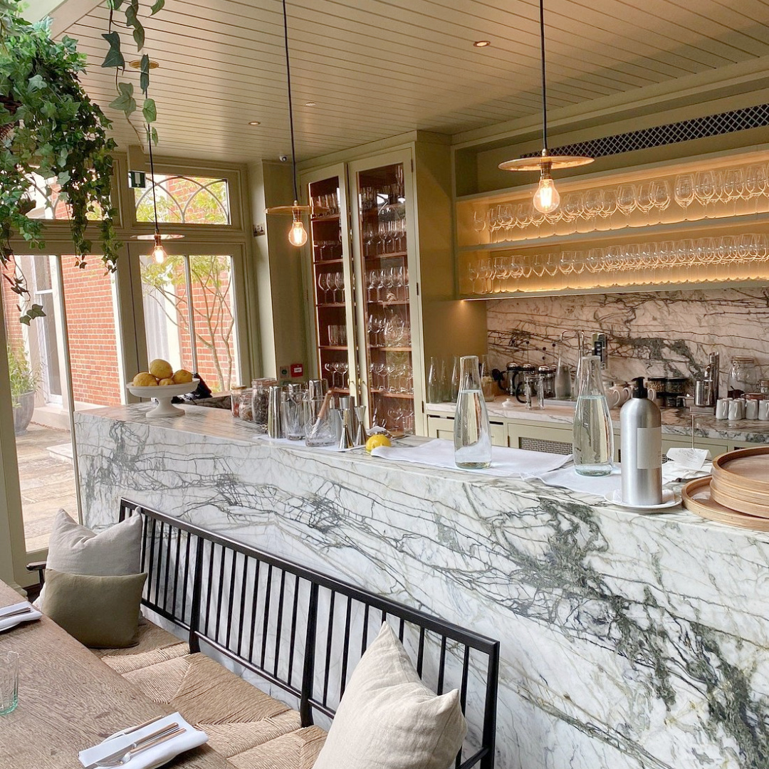 Rustic wood bar and marble shelves at Heckfield Place (Hampsire, England), a cozy luxurious hotel on 400 acres of English countryside - design by Ben Thompson. #heckfieldplace #englishcountrystyle