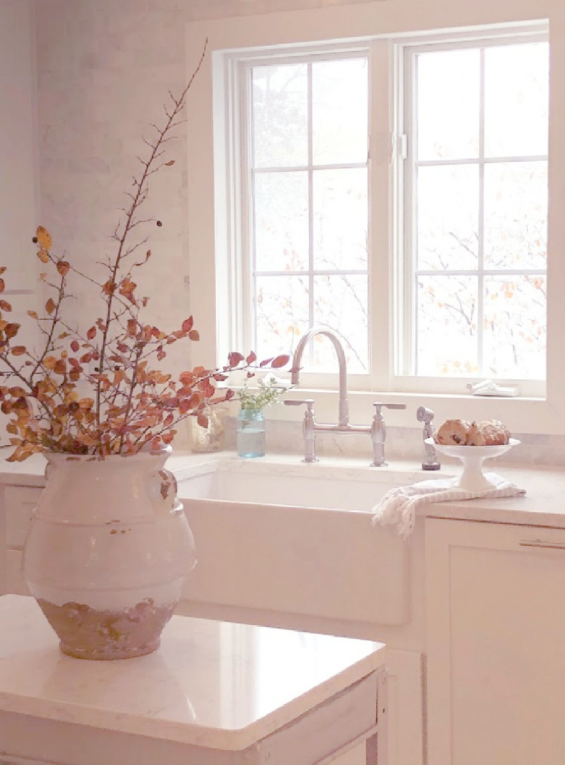 White Shaker style kitchen with Viatera Minuet quartz countertops and industrial work cart - Hello Lovely Studio. #whiteclassickitchen #viateraminuet #whitequartz