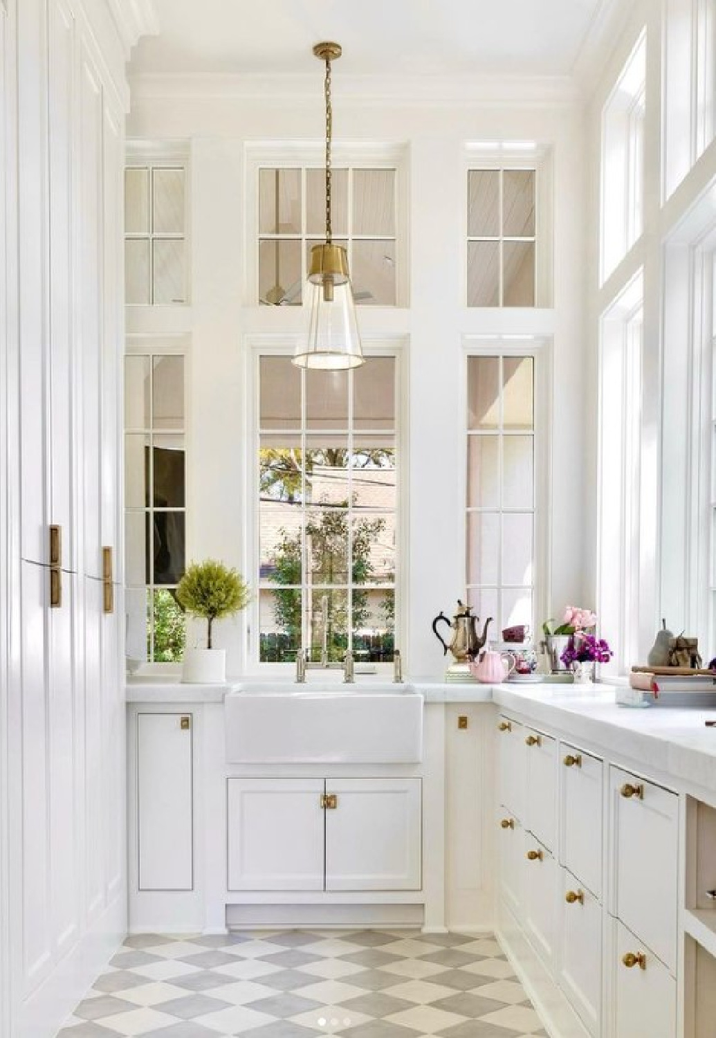 Breathtaking white kitchen pantry with checkered floors and farm sink - Holly Bell Design. #kitchenpantry #whitekitchendesign #coastalgrandmother
