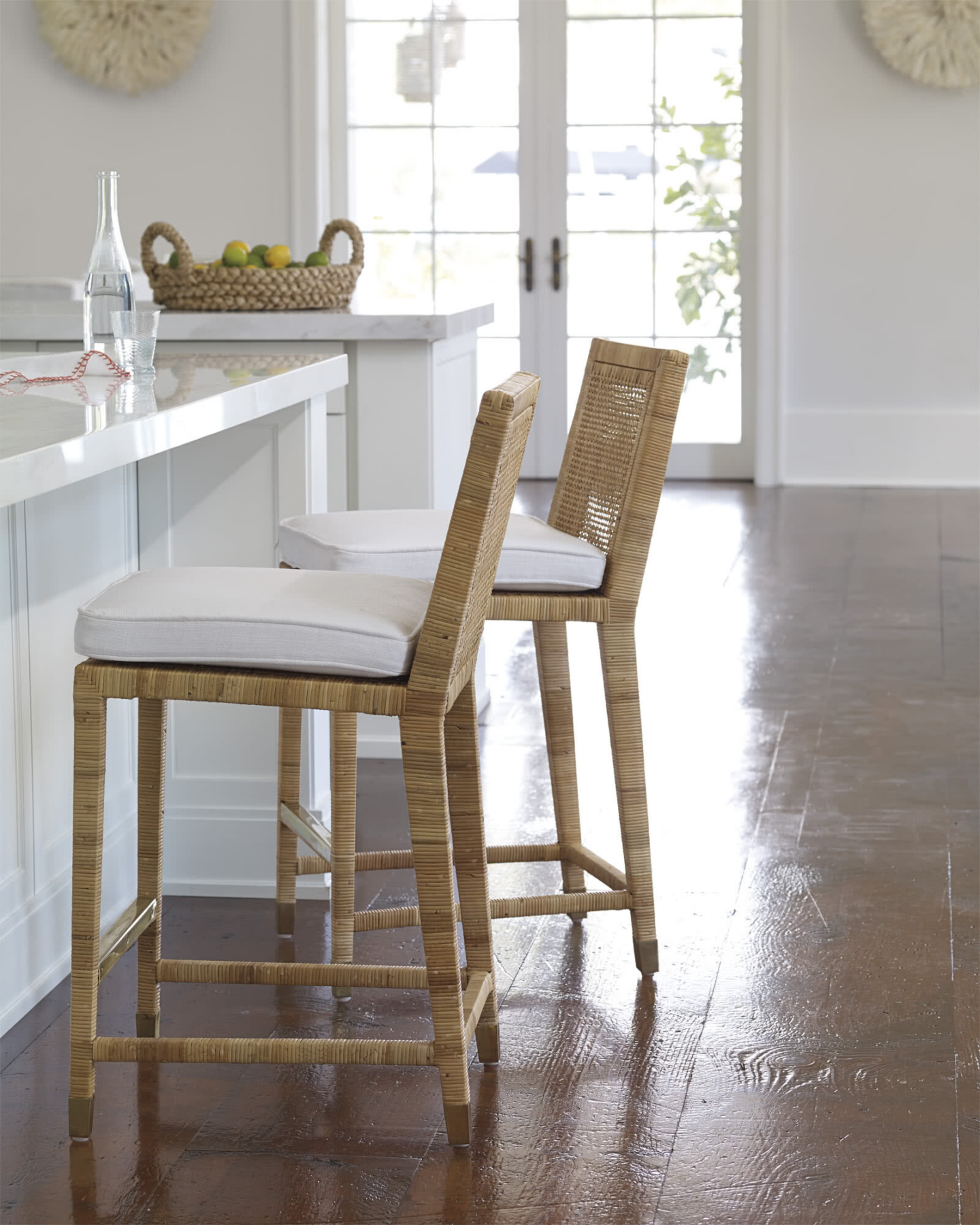 Serena & Lily counter stools add natural warmth and woven texture to a white kitchen. #counterstools #coastalkitchens
