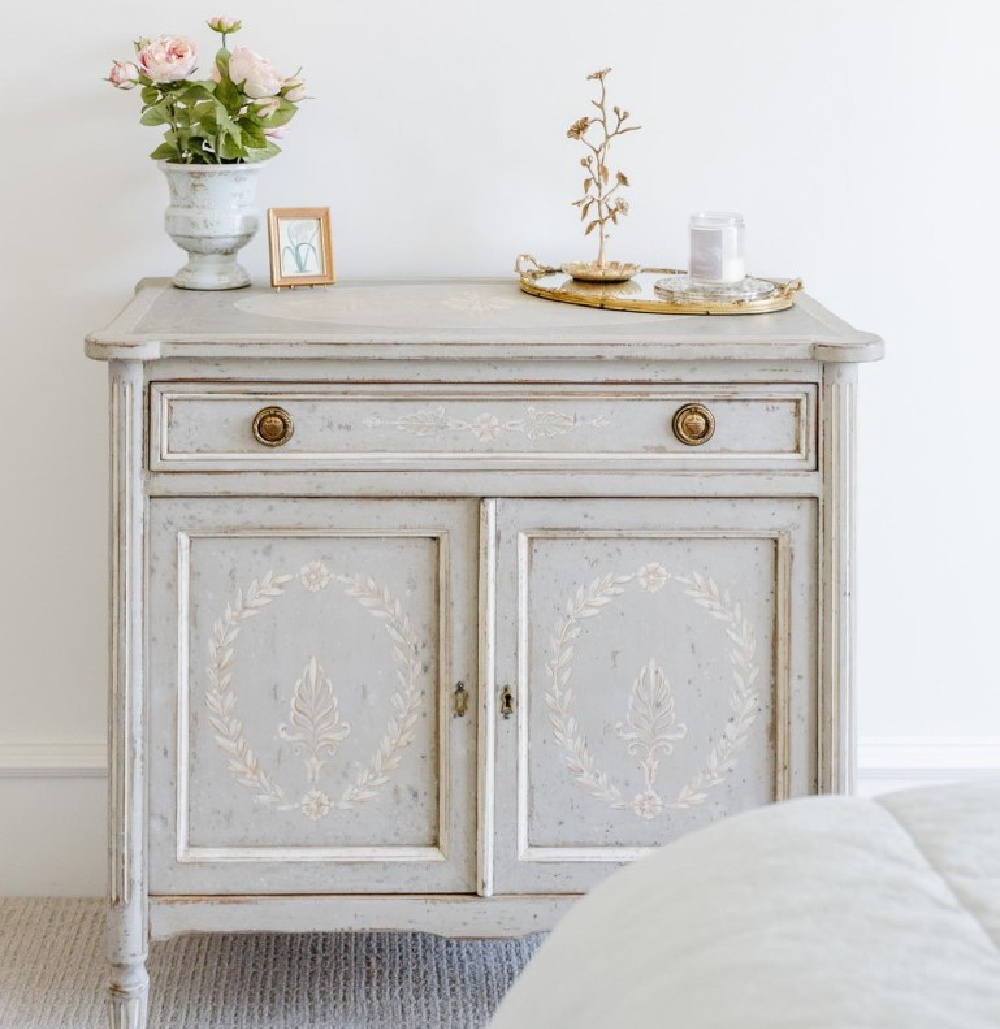 Beautiful light grey commode with handpainted detail and brass hardware - Brittany Jones design (BeccaLeaPhoto). #frenchcountrycabinet