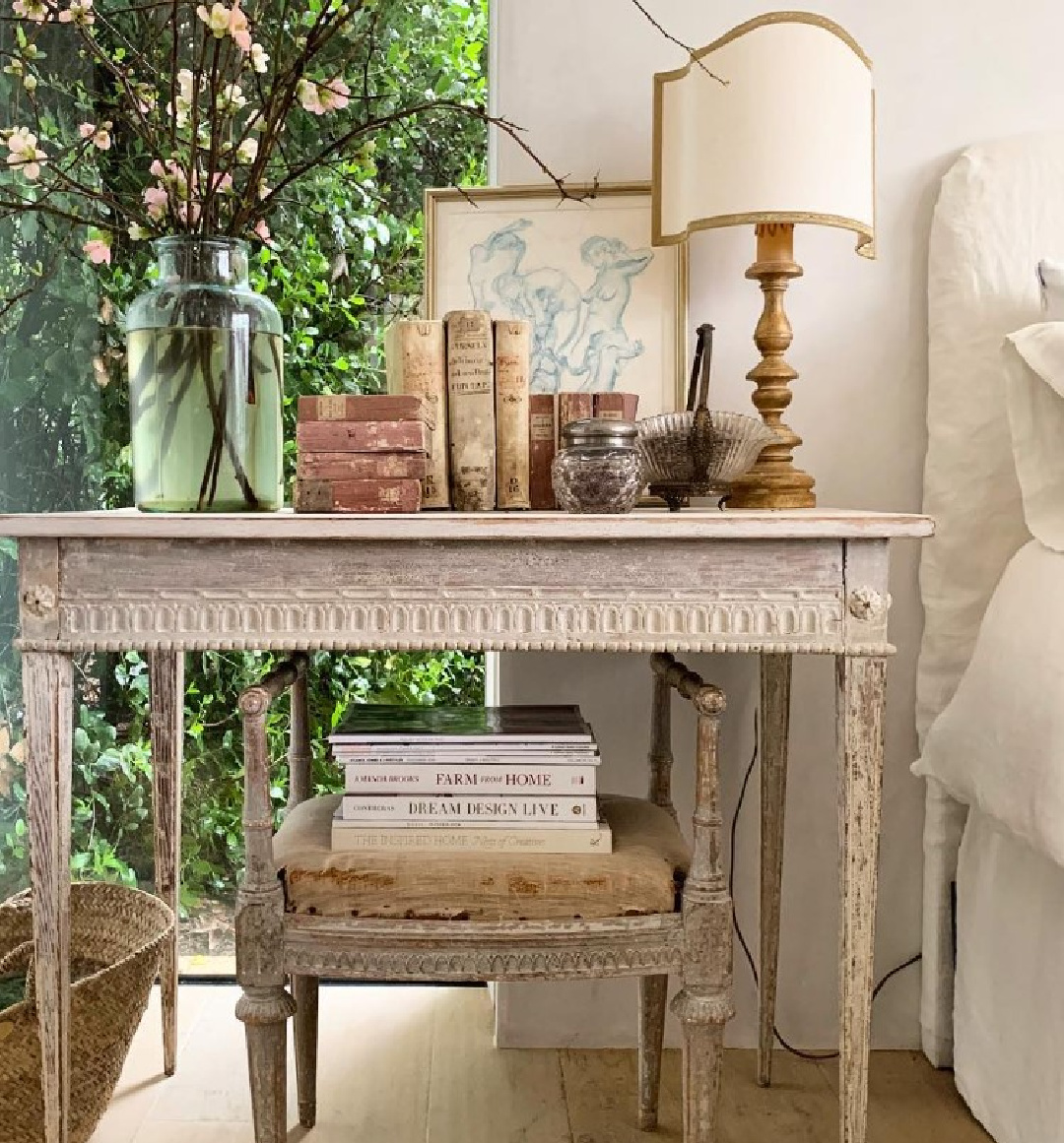 Serene modern French farmhouse bedroom at Patina Farm with white linen bedding, Swedish bedside tables, and design by Brooke Giannetti - Velvet and Linen. #patinafarm #modernfrenchbedroom