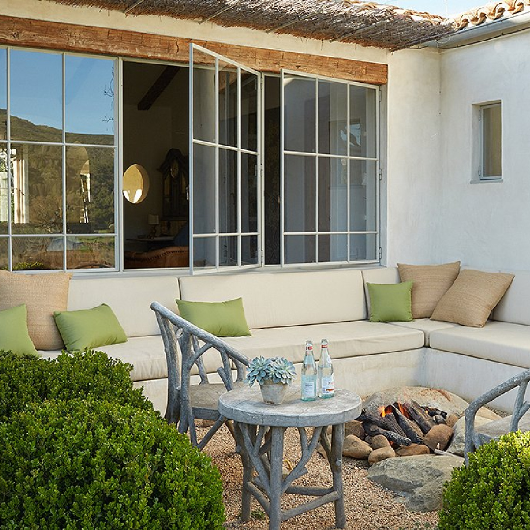 Charming firepit with built-in seating - Patina Farm (Brooke Giannetti) European country farmhouse in Ojai. #patinafarm #firepit #patios