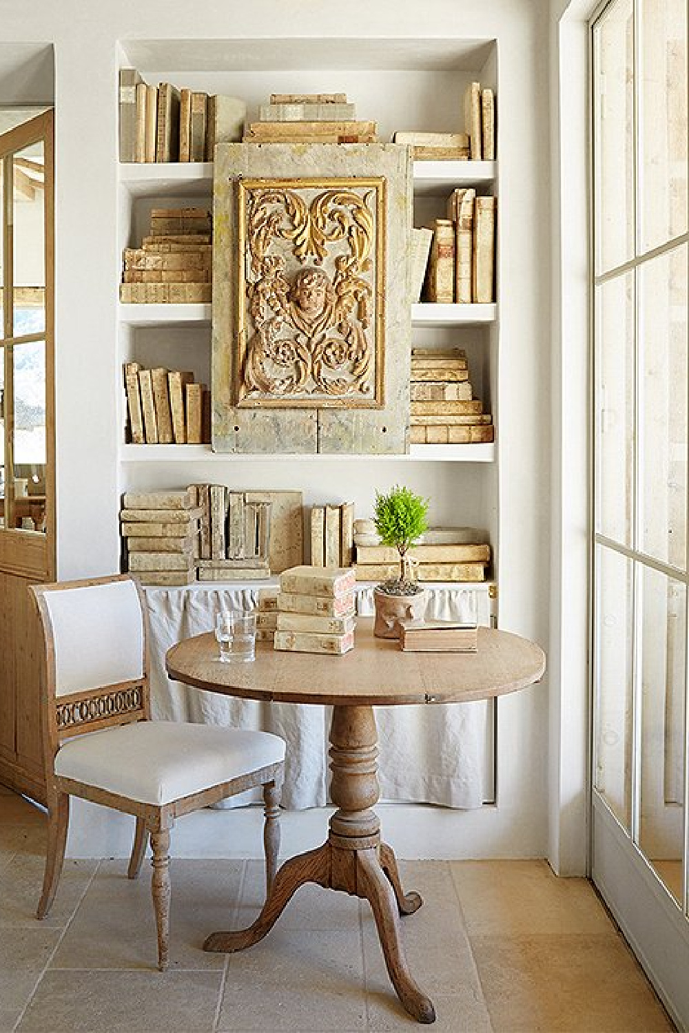 Shelves of antique vellum books in office - Patina Farm (Brooke Giannetti) European country farmhouse in Ojai. #patinafarm #vintagemodern #modernrustic #frenchfarmhouse