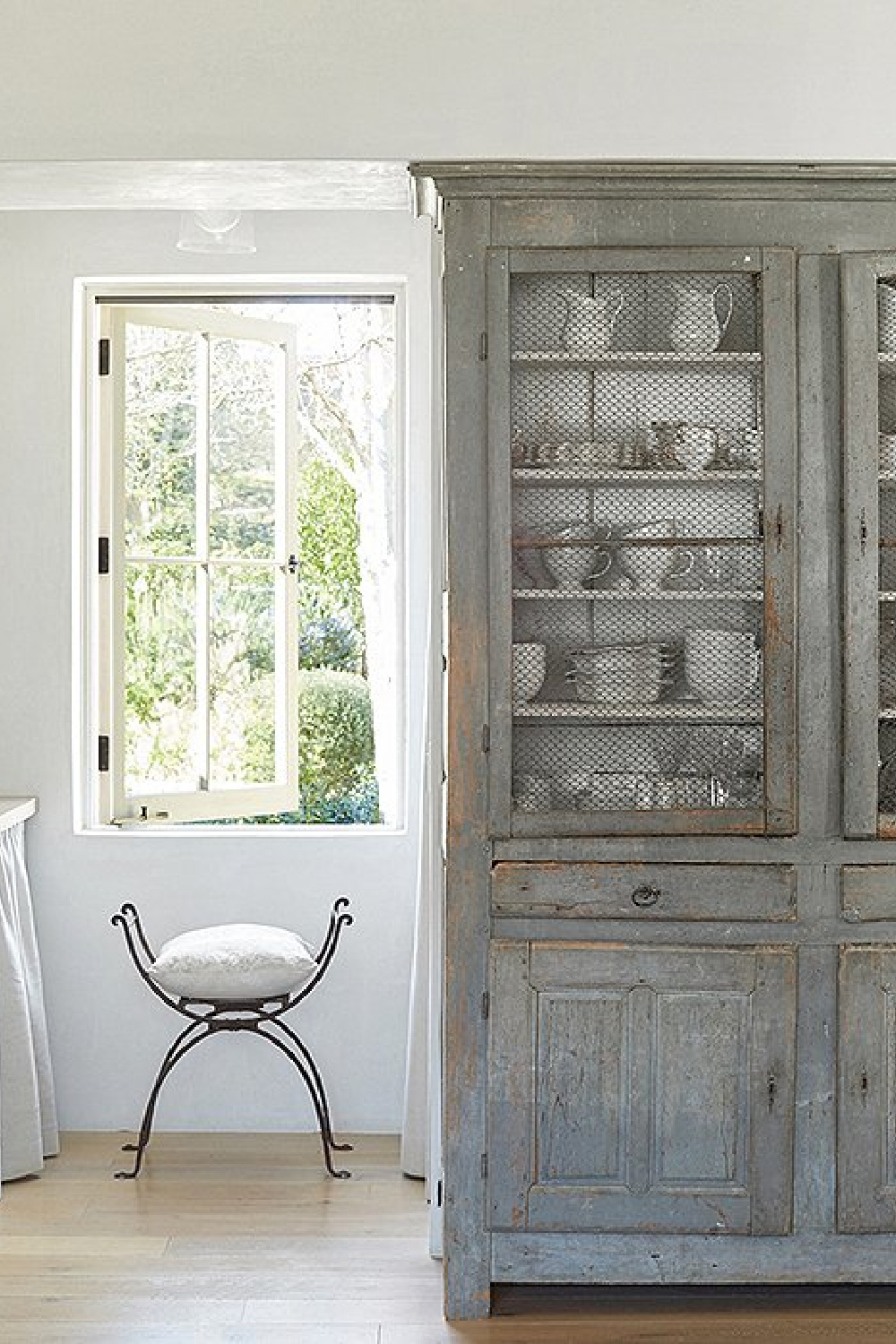 Antique French cupboard holding dishes in kitchen - Patina Farm (Brooke Giannetti) European country farmhouse in Ojai. #patinafarm #vintagemodern #modernrustic #frenchkitchens