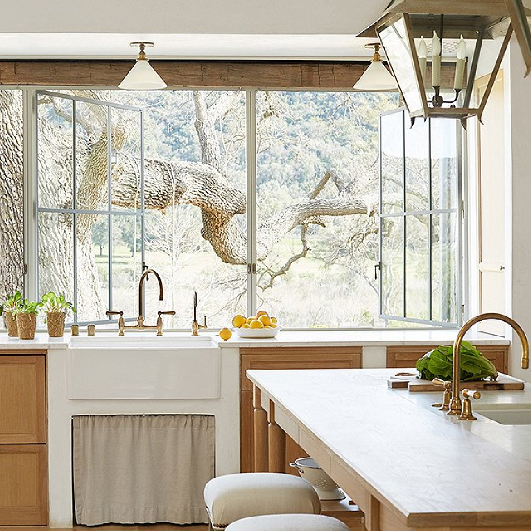 Farm sink overlooks ancient tree in kitchen - Patina Farm (Brooke Giannetti) European country farmhouse in Ojai. #patinafarm #vintagemodern #modernrustic #frenchkitchens