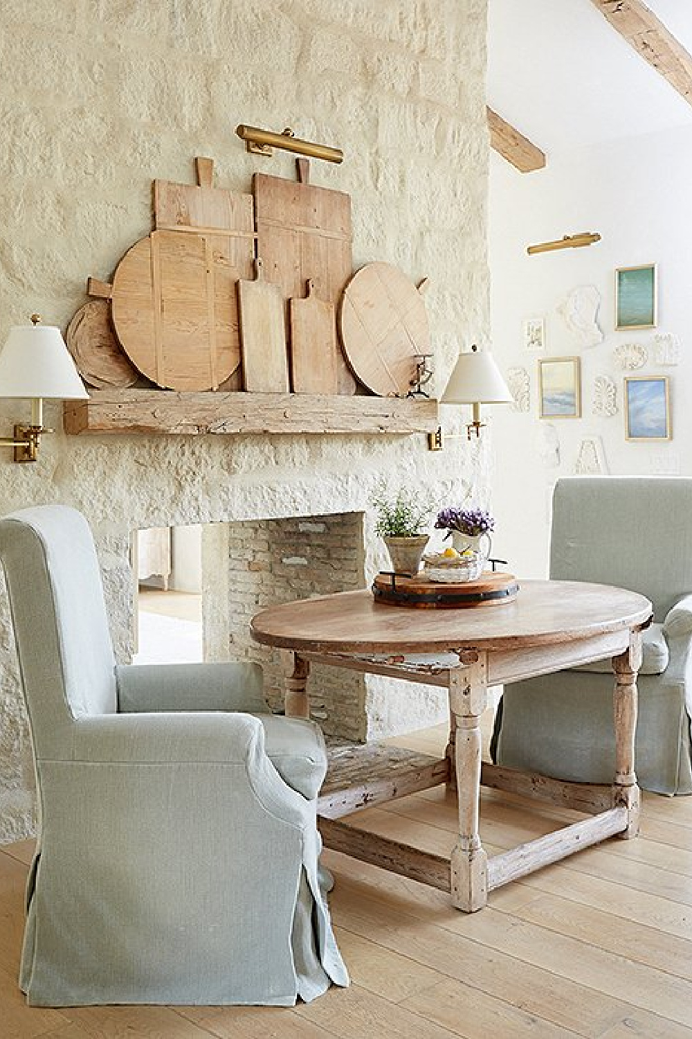 Limestone fireplace in kitchen nook - Patina Farm (Brooke Giannetti) European country farmhouse in Ojai. #patinafarm #vintagemodern #modernrustic #frenchfireplace