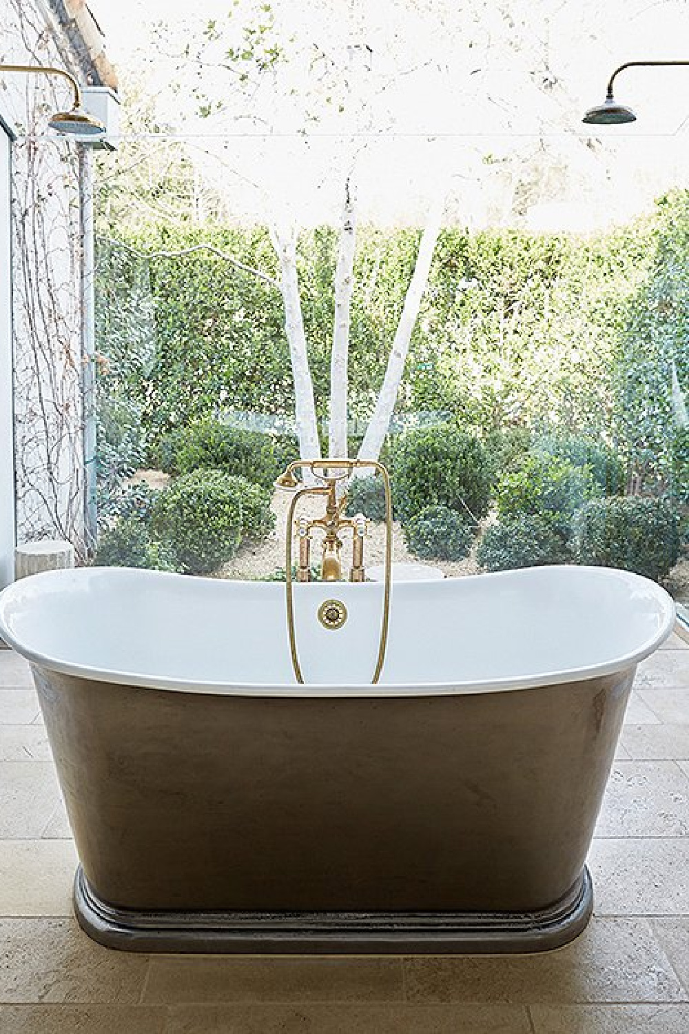 Soaking tub with glass wall - Patina Farm (Brooke Giannetti) European country farmhouse in Ojai. #patinafarm #vintagemodern #modernrustic #bathroomdesign