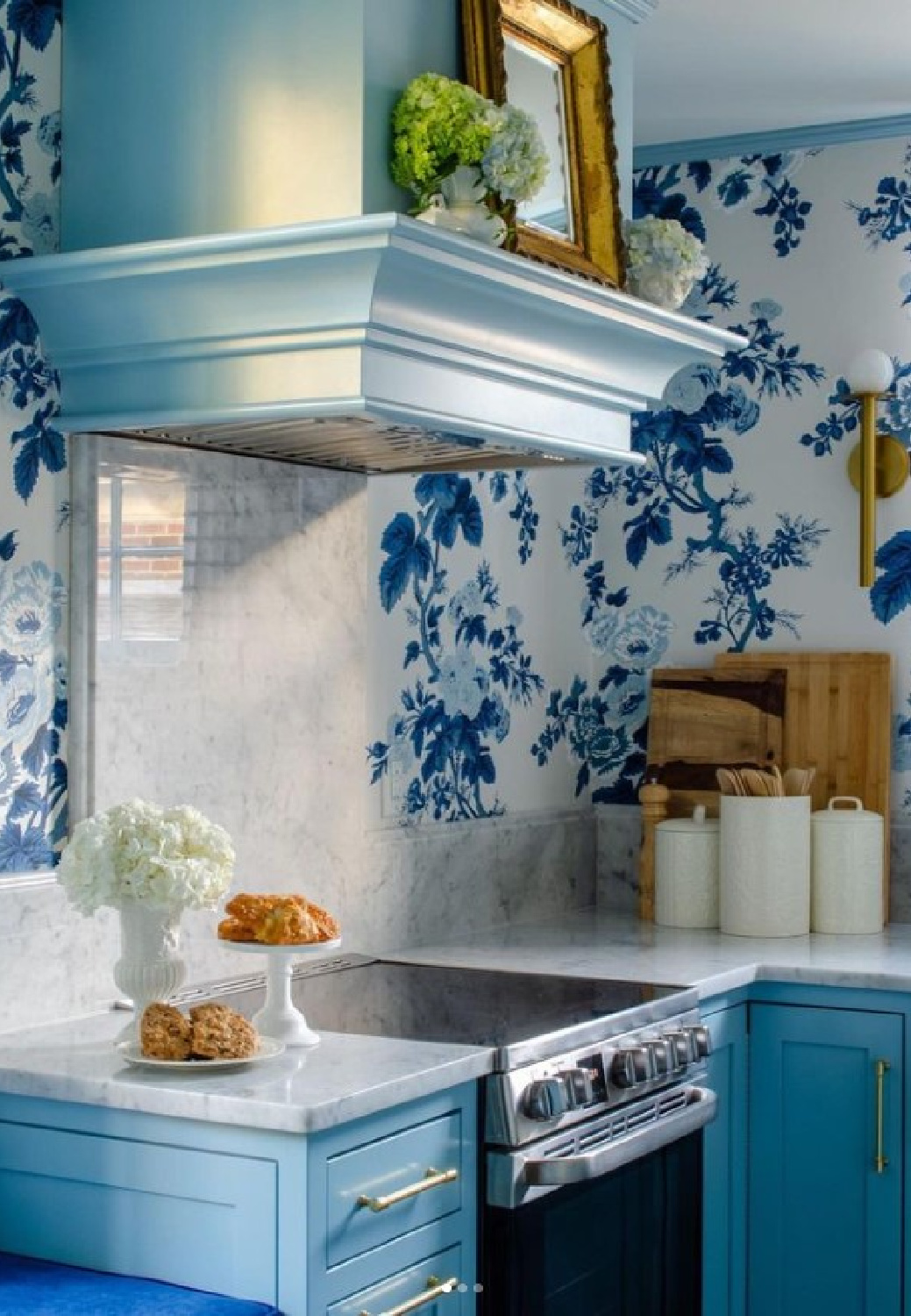 Charming turquoise blue kitchen cabinets and range hood with blue floral wallpaper - Shannon Meyer Roberts. #bluekitchens #turquoisecabinets