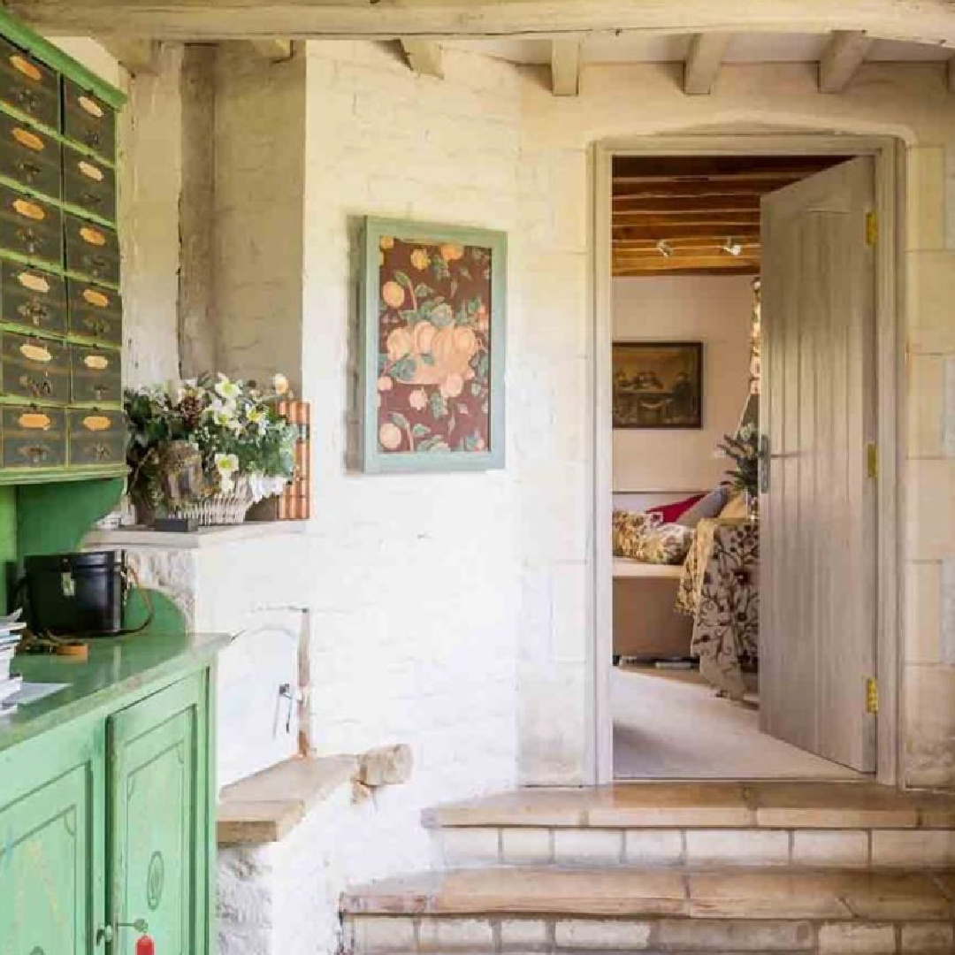 Charming entrance with green cupboard in Sixpenny Cottage - a vacation rental in the Cotswolds.