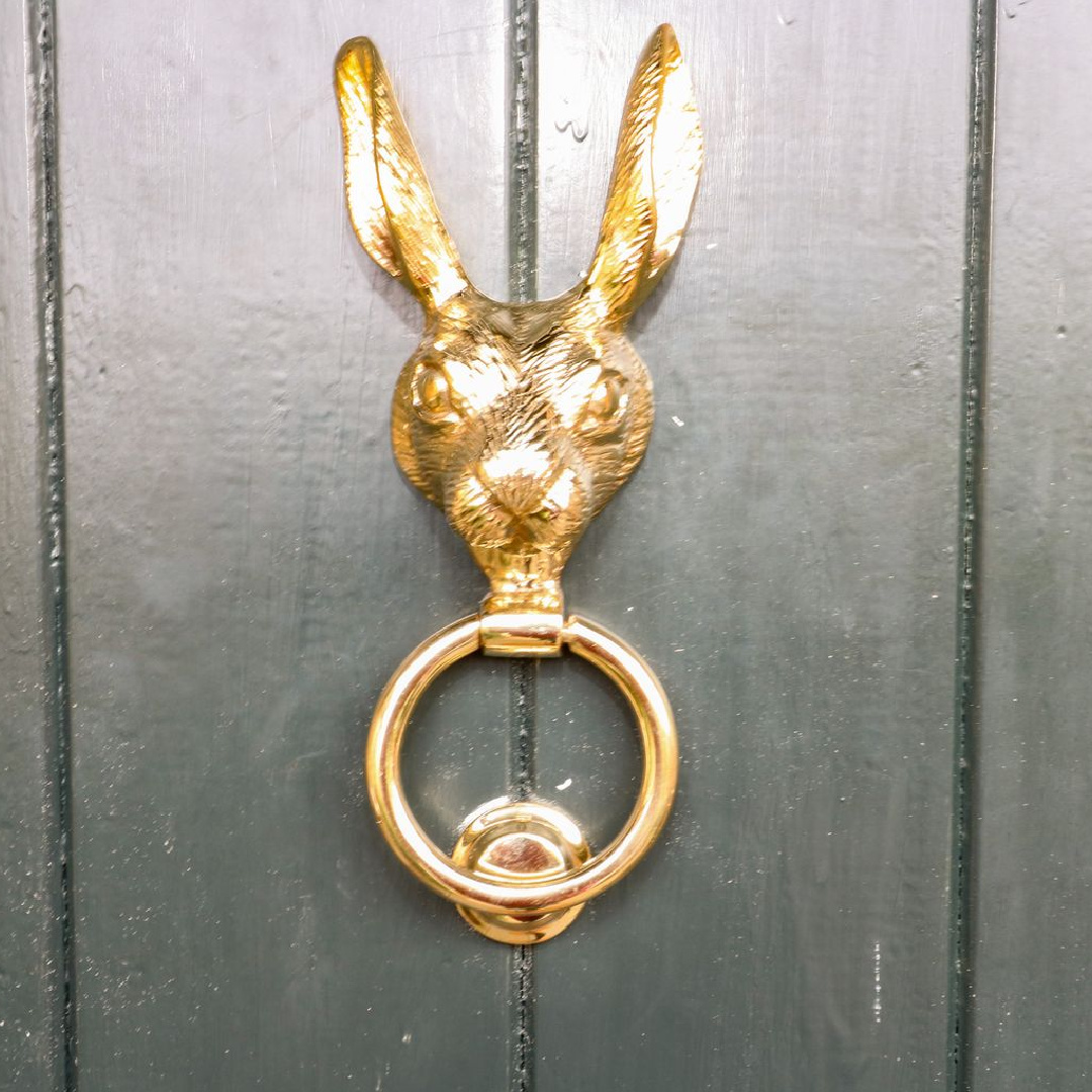 Brass rabbit door knocker on a Cotswolds cottage.