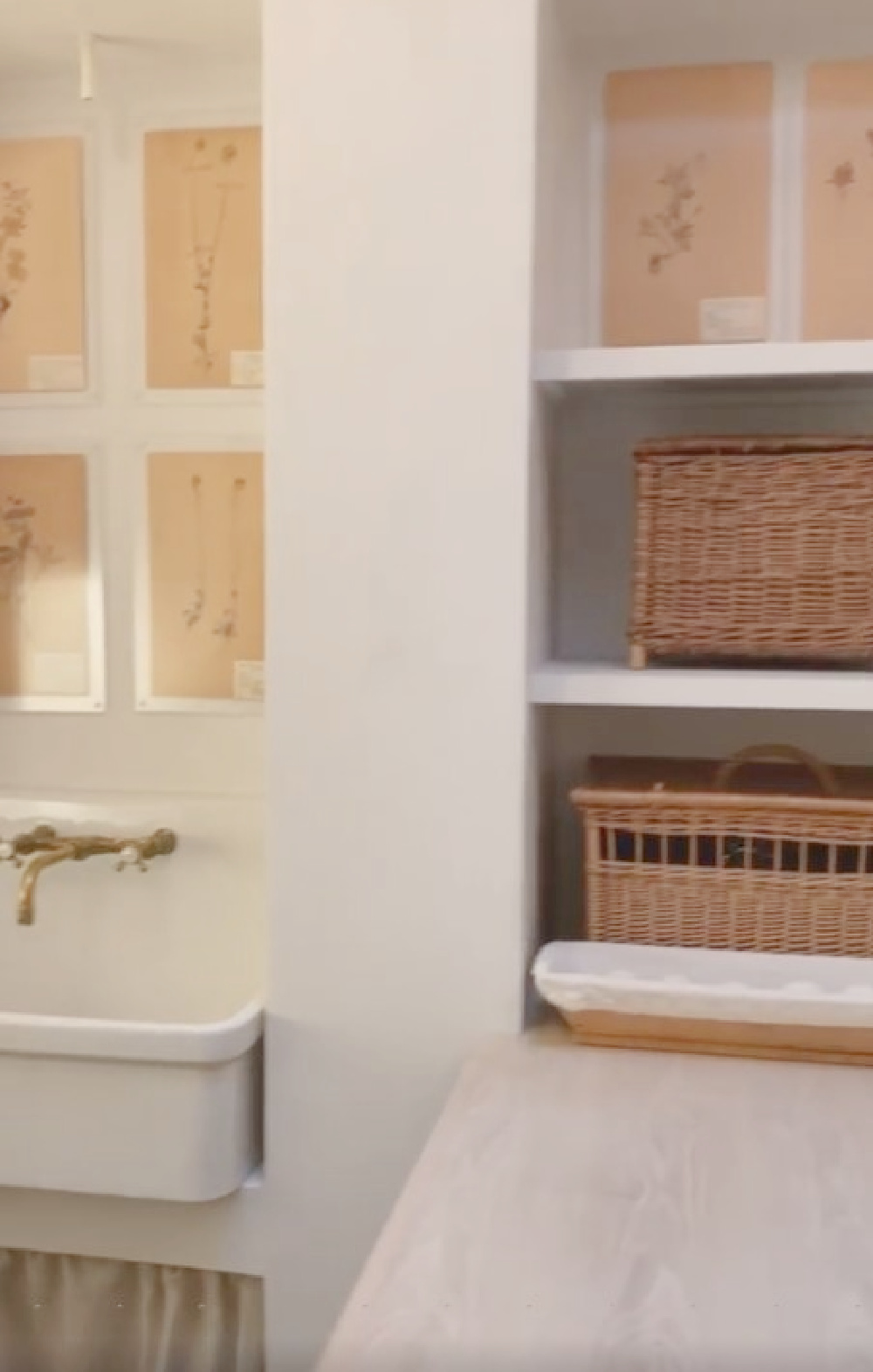 Patina Farm laundry room with plaster shelves, vintage herbarium, antique French baskets, and a skirted farm sink! Brooke Giannetti designed the space exquisitely. #laundrooms #frenchcountry