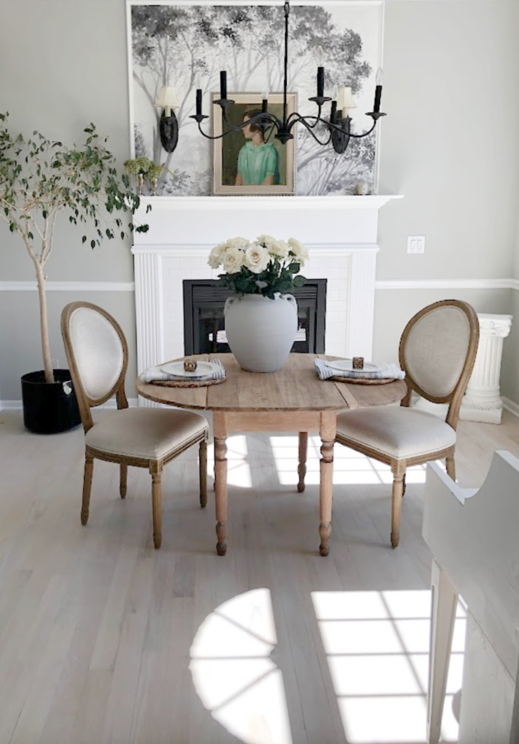 Hello Lovely's entry and dining room with tree mural wallpaper and light oak floors. #diningrooms #treemural