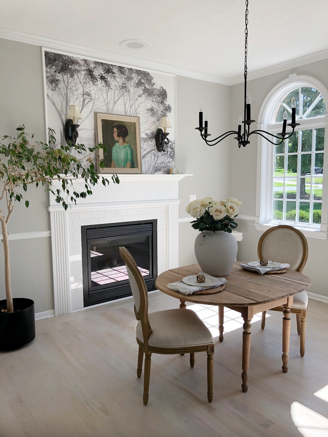 Hello Lovely's entry and dining room with tree mural wallpaper and light oak floors. #diningrooms #treemural