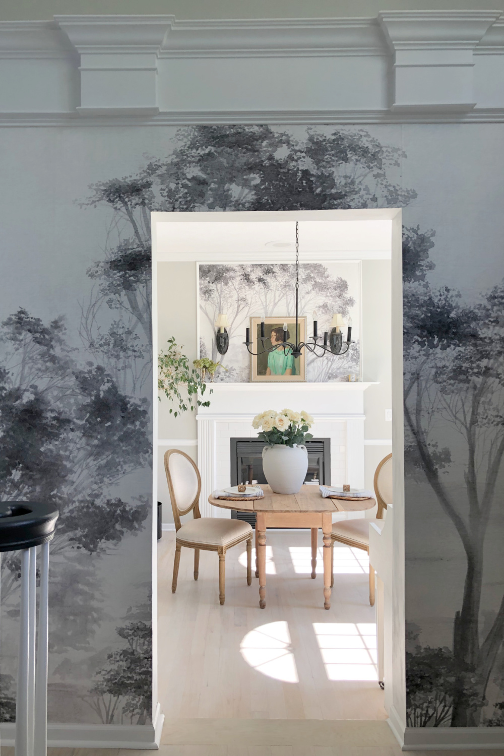 Hello Lovely's entry and dining room with tree mural wallpaper and light oak floors. #diningrooms #treemural