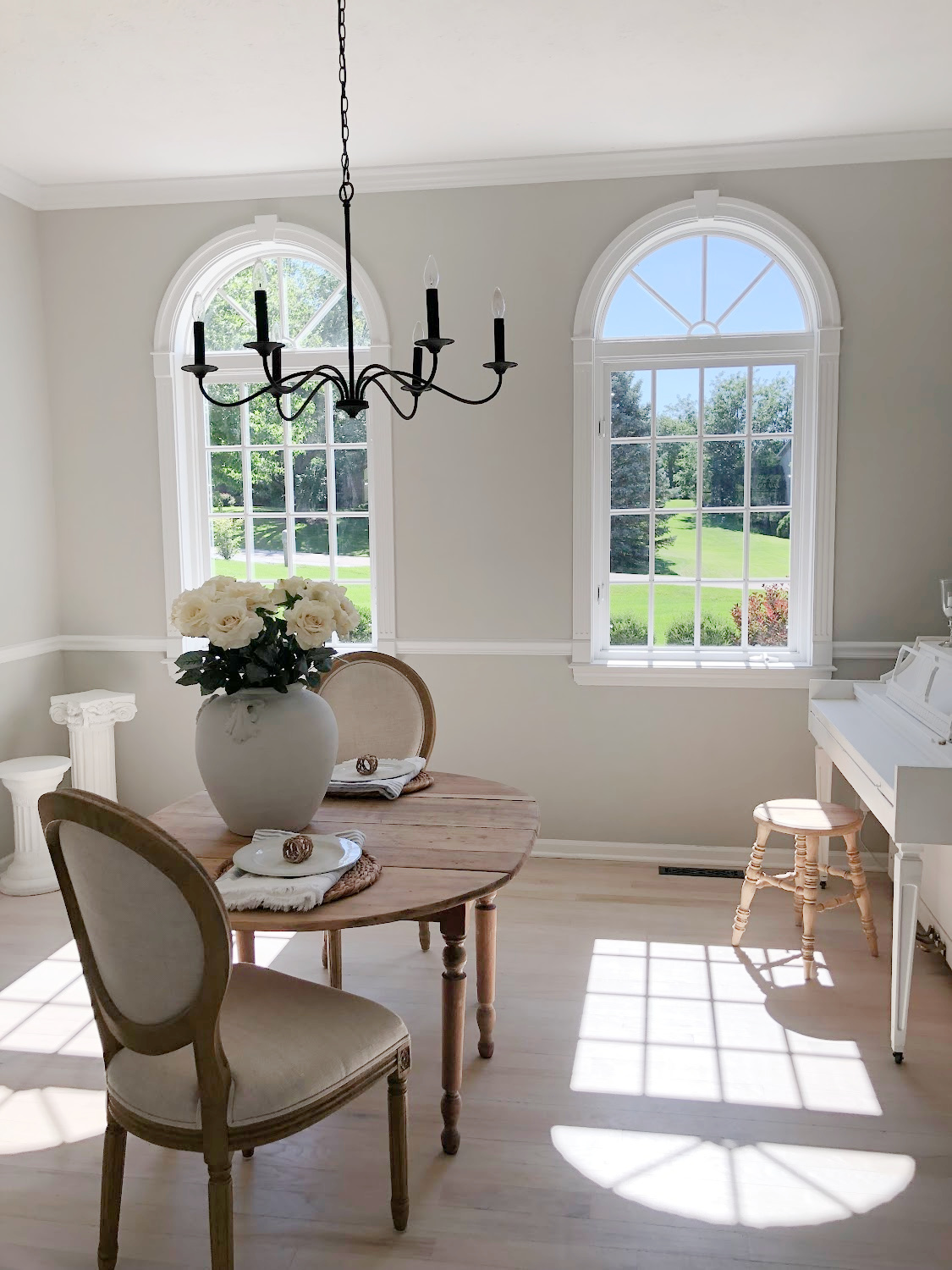 Hello Lovely's entry and dining room with tree mural wallpaper and light oak floors. #diningrooms #treemural