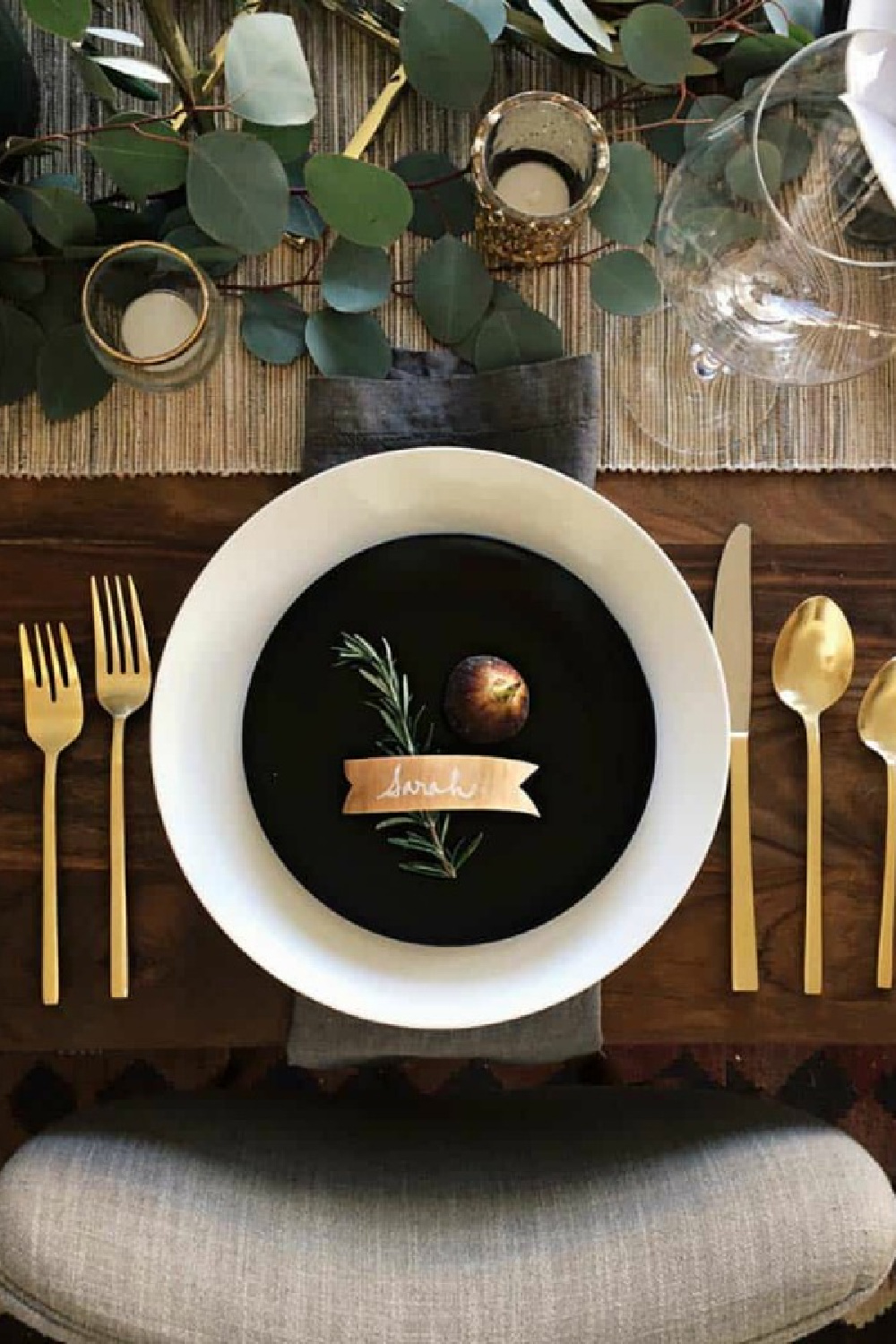 Thanksgiving placesetting with black and gold and a simple rosemary accent - Sarah Sherman Samuel. #thanksgivingtablescape #prettyplacesettings