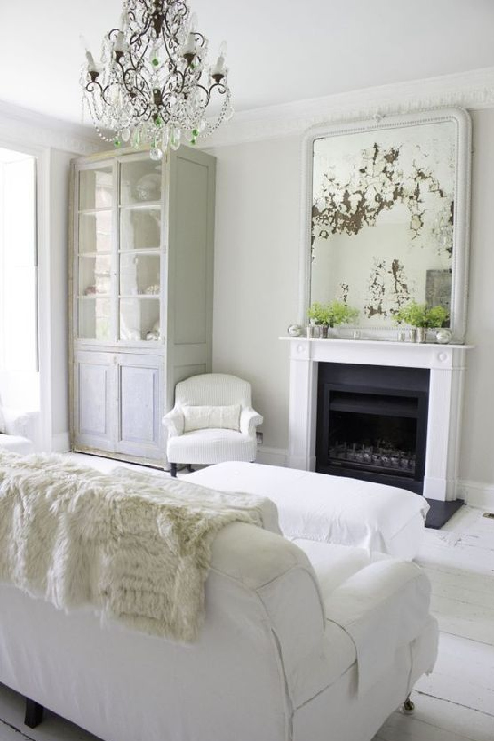 Fireplace in white on white room. Multiple shades of white mix for a glorious cloud-like interior. Scandinavian style white Nordic French design details as well as spare decor style meet English countryside charm in "The Hatch," a photographic location in Wiltshire. Design: Atlanta Bartlett & Dave Coote of the Beach Studios. 