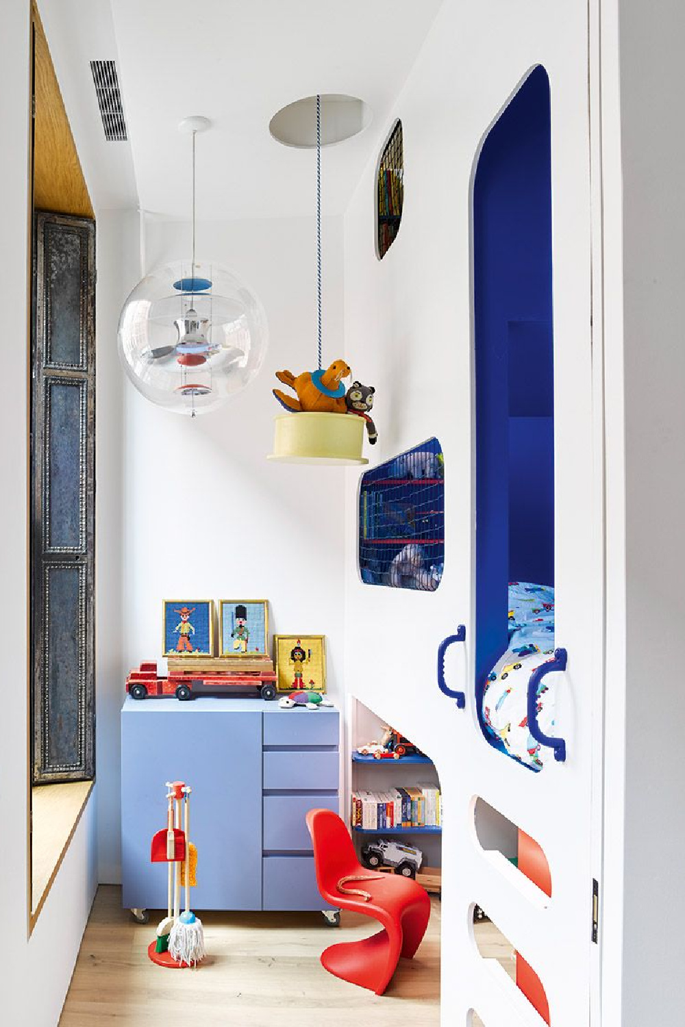 Cutaways in the plywood fronting create a ladder to lower sleeping birth in this imaginative architectural bunk space - photo by Annie Schlechter for The Bunk Bed Book (Gibbs Smith, 2022) by Laura Fenton. #bunkbeds