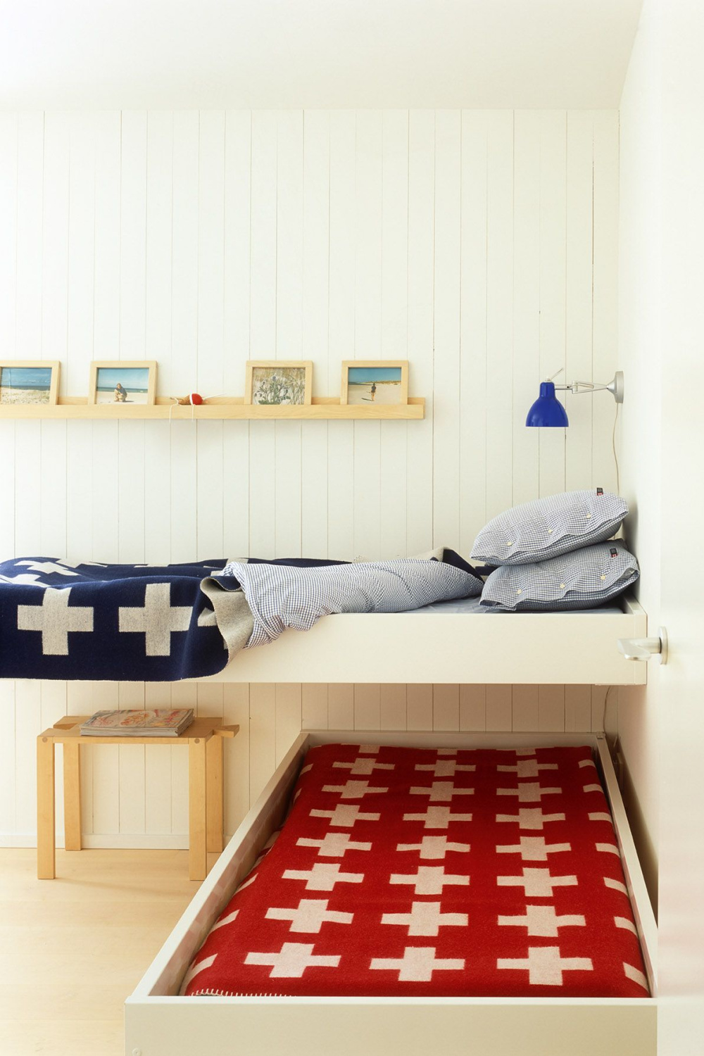 L-shaped custom bunks with cross wool blankets in red and blue -from The Bunk Bed Book (Gibbs Smith, 2022) by Laura Fenton. #bunkbeds