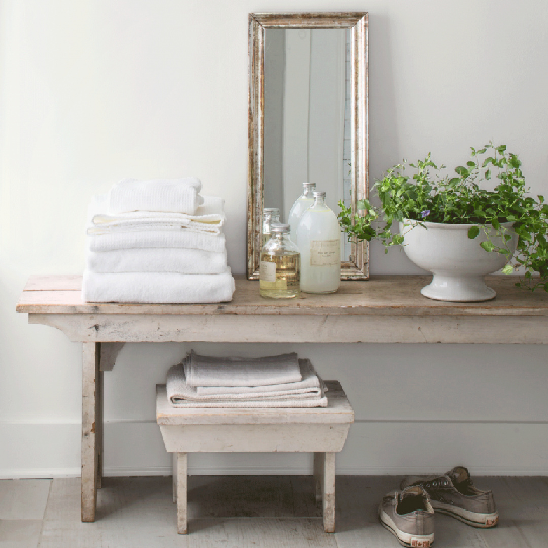 Primitive farm bench in a bath at Nancy Fishelson's renovated historic home in Killingworth - Country Living magazine/Helen Norman/Janna Lufkin.