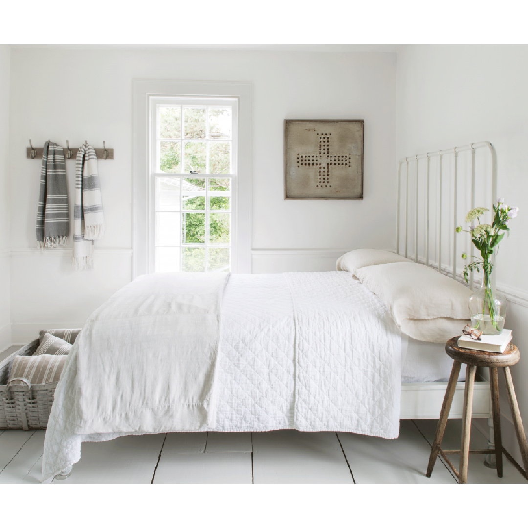 White bedroom in Nancy Fishelson's renovated historic home in Killingworth - Country Living magazine/Helen Norman/Janna Lufkin.