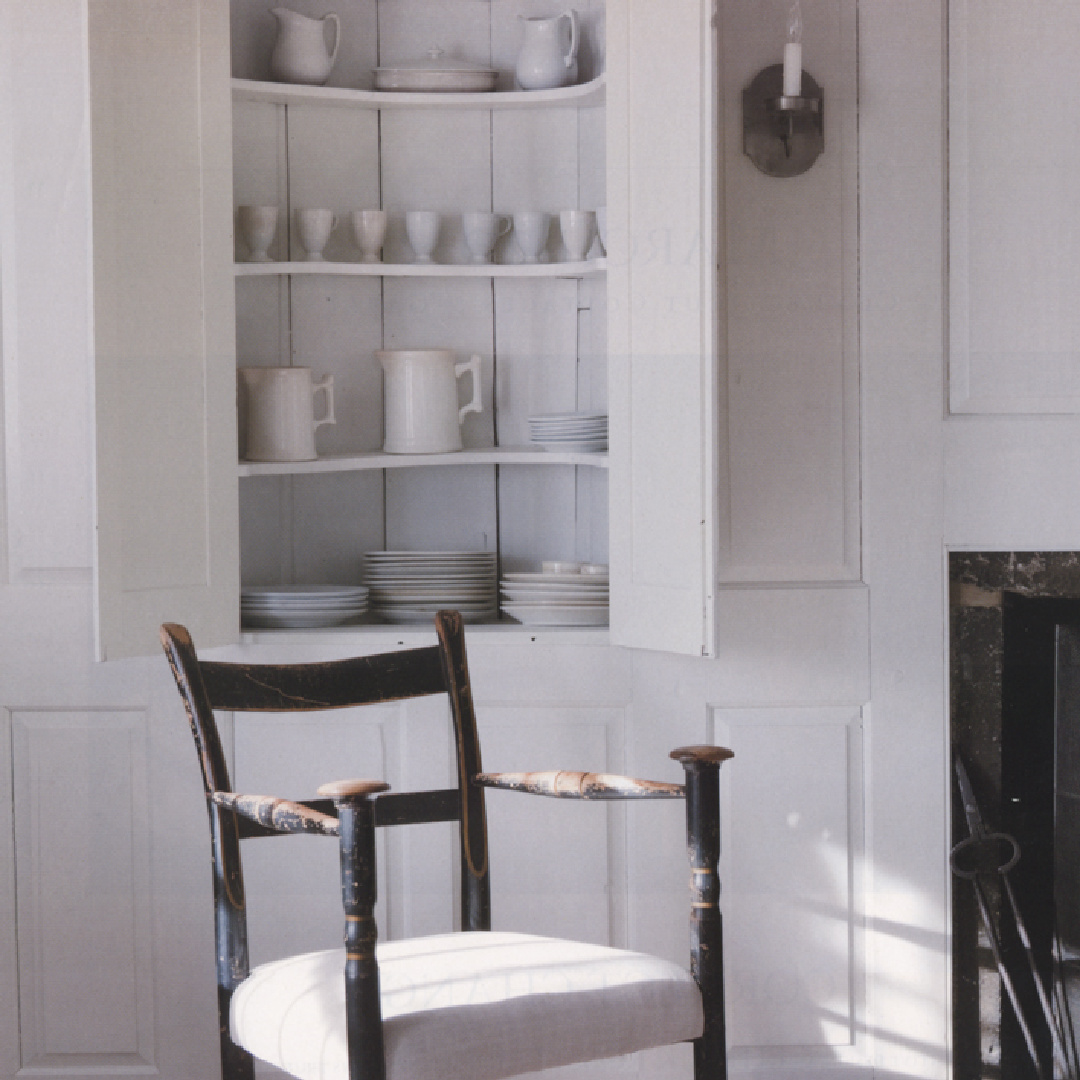 Ironstone in built-in cupboard at Nancy Fishelson's renovated historic home in Killingworth - Country Living magazine/Helen Norman/Janna Lufkin.