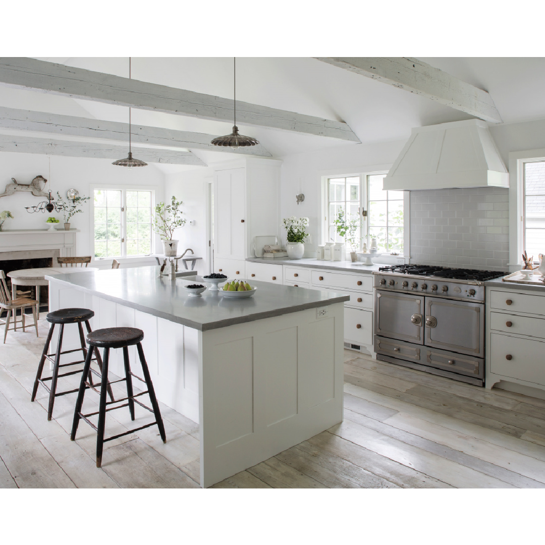 Beautiful white country kitchen with La Cornue range in Nancy Fishelson's renovated historic home in Killingworth - Country Living magazine/Helen Norman/Janna Lufkin.