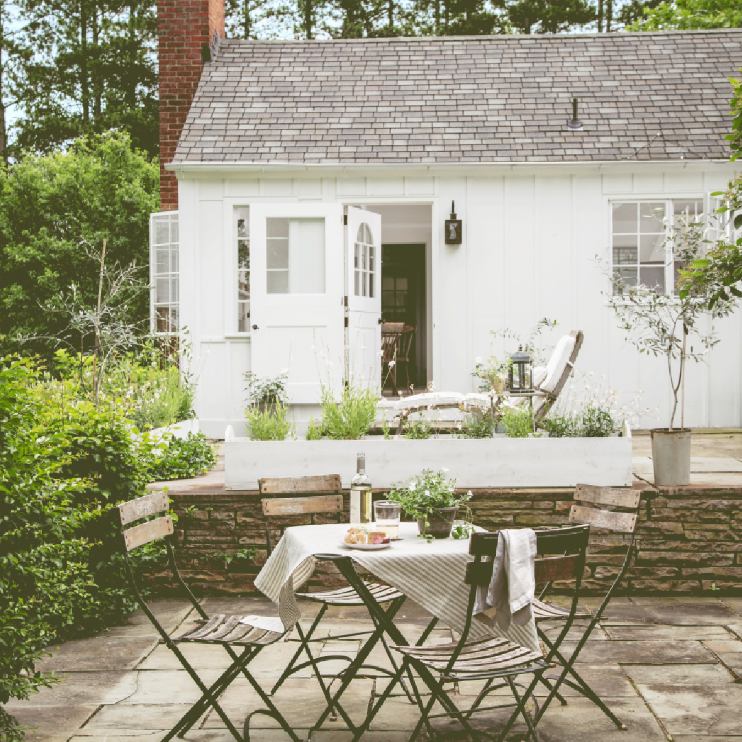 Exterior and patio of Nancy Fishelson's renovated historic home in Killingworth - Country Living magazine/Helen Norman/Janna Lufkin.