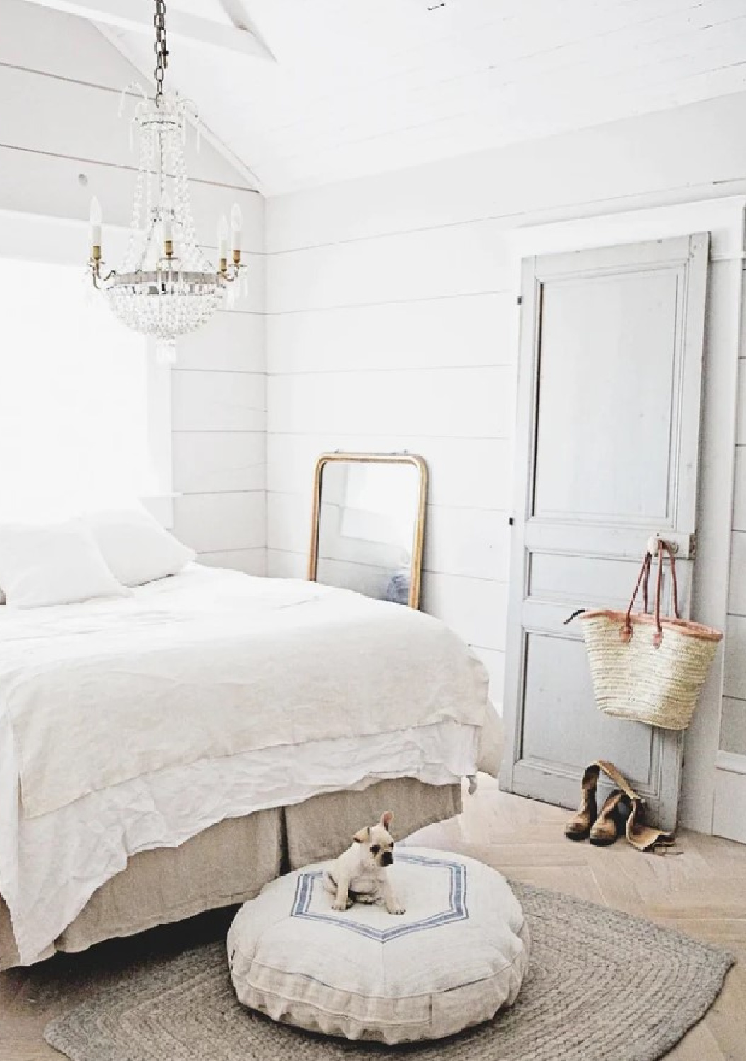Dreamy Whites Atelier - French farmhouse bedroom with crystal chandelier, grain sack dog bed and French market basket on door knob.