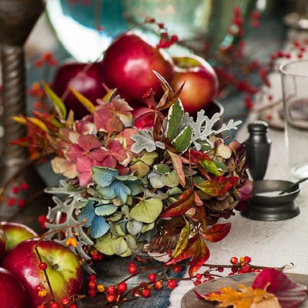 Thanksgiving tablescape with orange and blue in a lovely barn featured in Southern Living - Helen Norman. #thanksgivingtable #rustictablescape #falltablescape