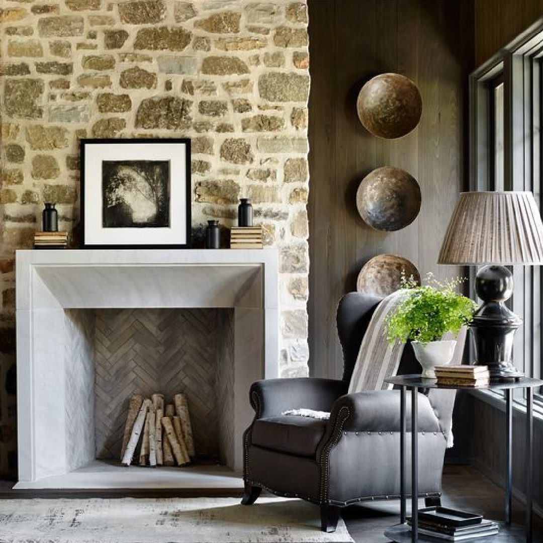 Magnificent rustic stone wall with fireplace, herringbone interior, and wingchair. Modern rustic design by architect Jeffrey Dungan for Farmhouse on Shades Creek.. 
