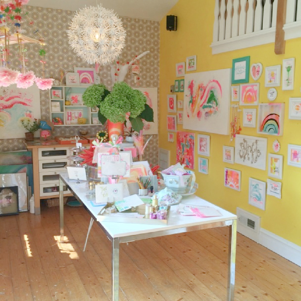 Electric yellow walls of studio. Be inspired by this photo gallery of vibrant colorful beachy boho interior design from artist Jenny Sweeney's Chicagoland home. Her art has been lifting spirits and opening hearts to wonder - see how it lives large in a charming suburban Tudor!