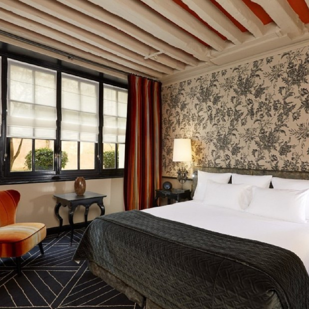 Charcoal grey and orange accents in a luxurious boutique hotel suite in Paris: Pavillon de la Reine.