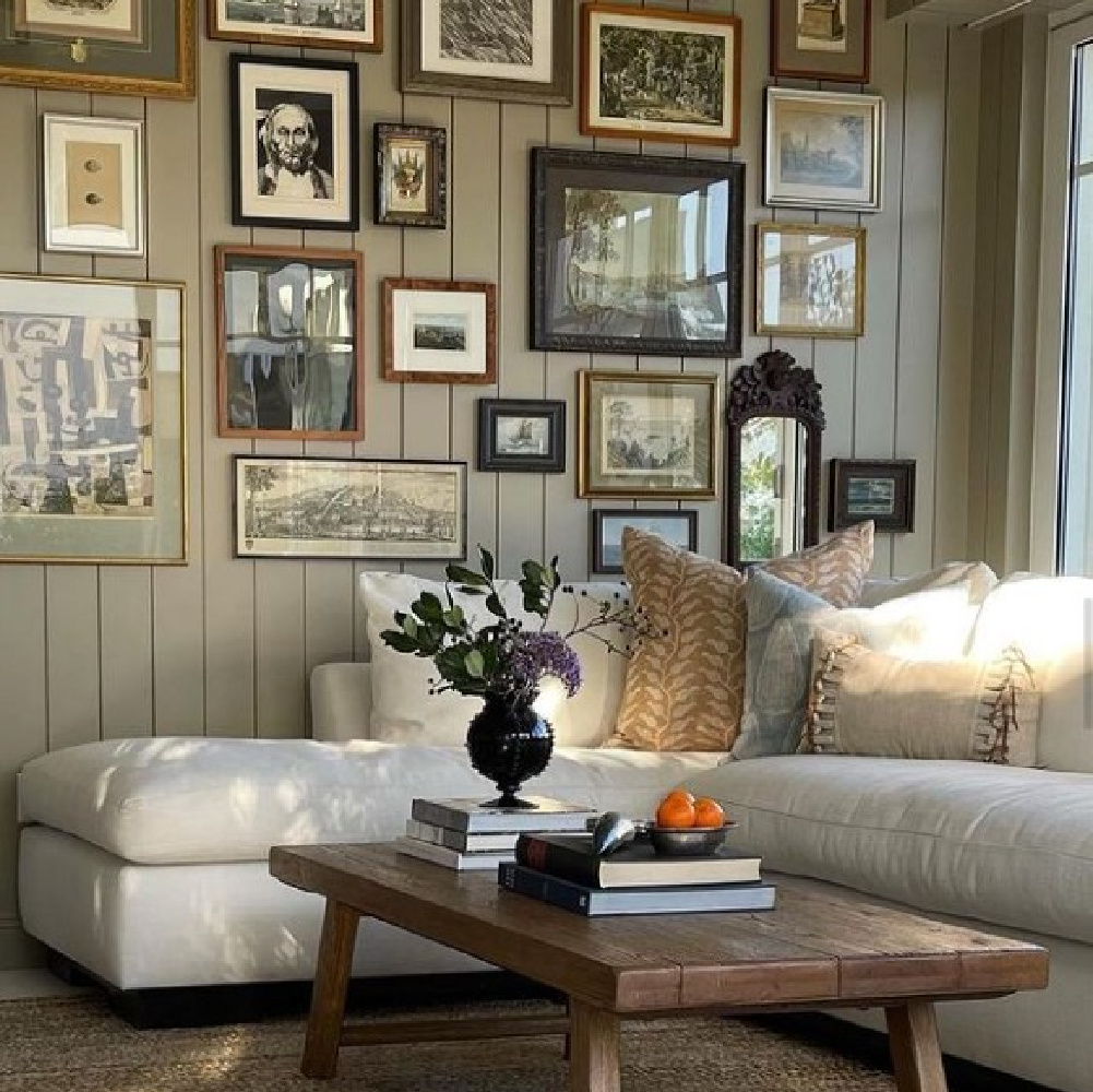 Gallery wall and sectional sofa in a cozy space by @m_m_interior_design