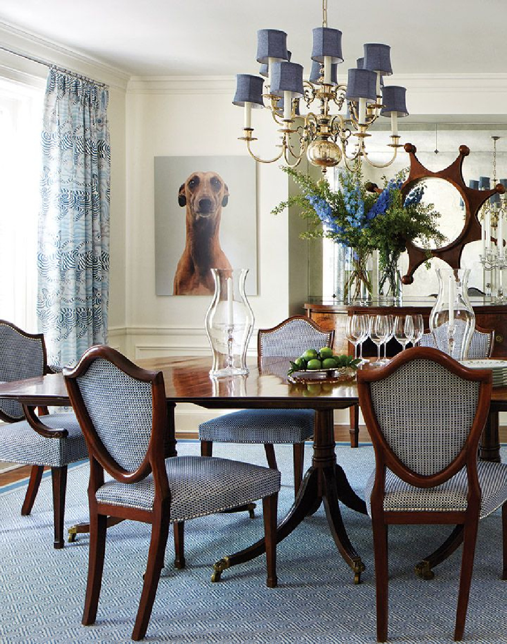 Regency style mahogany dining table and shield-back chairs in a dining room with modern Greyhound photography on walls - design by Anne Hepfer in MOOD (Gibbs Smith, 2022). #earthymodern