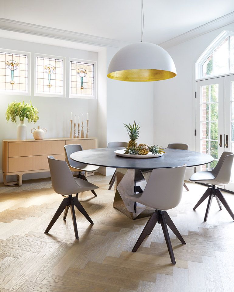 Round dining table with honed black marble top and dome pendant with gold leaf - design by Anne Hepfer in MOOD (Gibbs Smith, 2022). #earthymodern #diningrooms