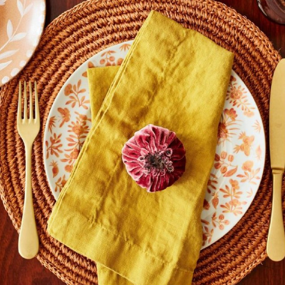Pomegranate themed fall tablescape with marigold napkins - Martha Stewart. #fallplacesetting #thanksgivingtable