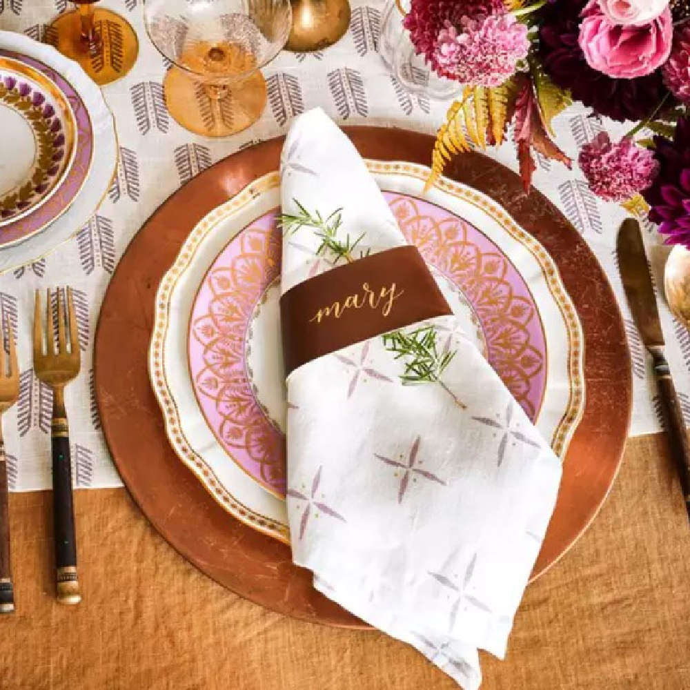 Thanksgiving place setting and tablescape with orange and pink - Southern Living Magazine. #thanksgivingtablescape #fallplacesetting